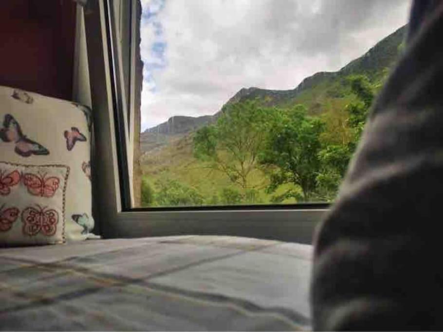 a bedroom with a view of a mountain view from a window at Snowdon Cottage in Dinorwic