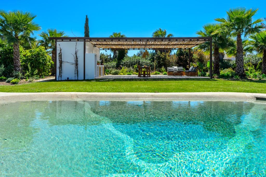 a swimming pool in front of a house at Villa Can Jaume Arabí de Baix in Puig D’en Valls