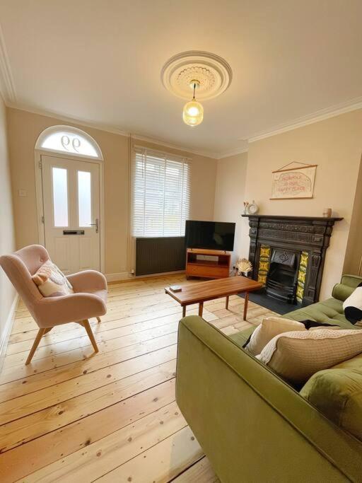 a living room with a couch and a fireplace at Family Friendly House in Norwich with Parking in Norwich