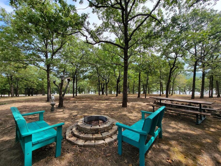 two blue benches and a fire pit in a park at Gigi's Spacious Lakefront with Boat Ramp Access!! Newly Remodeled, Sleeps 8! in Canadian
