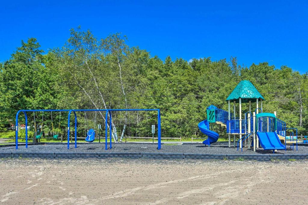 a playground with blue equipment in a park at Hot Tub and Resort Amenities Pocono Lake Retreat! in Pocono Lake