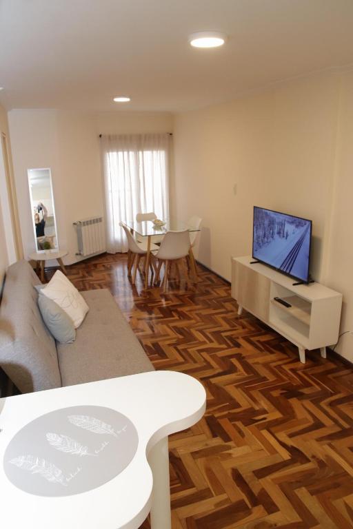 a living room with a couch and a flat screen tv at Parana 540 - Nueva Córdoba in Córdoba