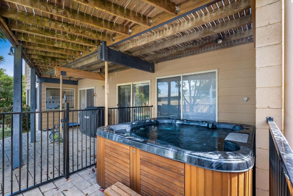 a hot tub on a balcony of a house at Woolamai Sands in Cape Woolamai