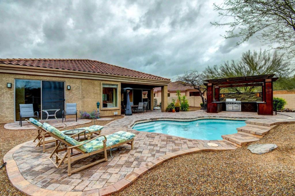 a backyard with a pool and a gazebo at Arizona Vacation Rental with Private Pool and Pergola! in Phoenix