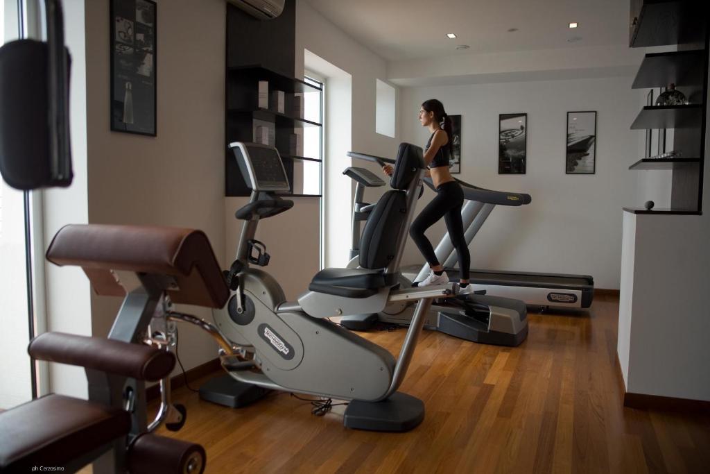 a woman running on a treadmill in a gym at Hotel Cetus in Cetara