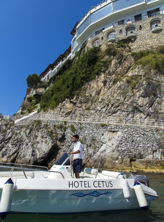 a man standing on a boat in the water at Hotel Cetus in Cetara