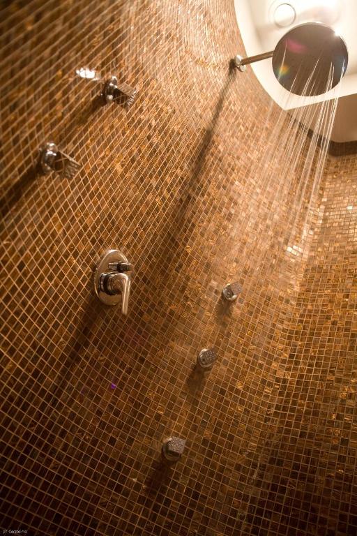 a bathroom with a shower and a tiled floor at Hotel Cetus in Cetara