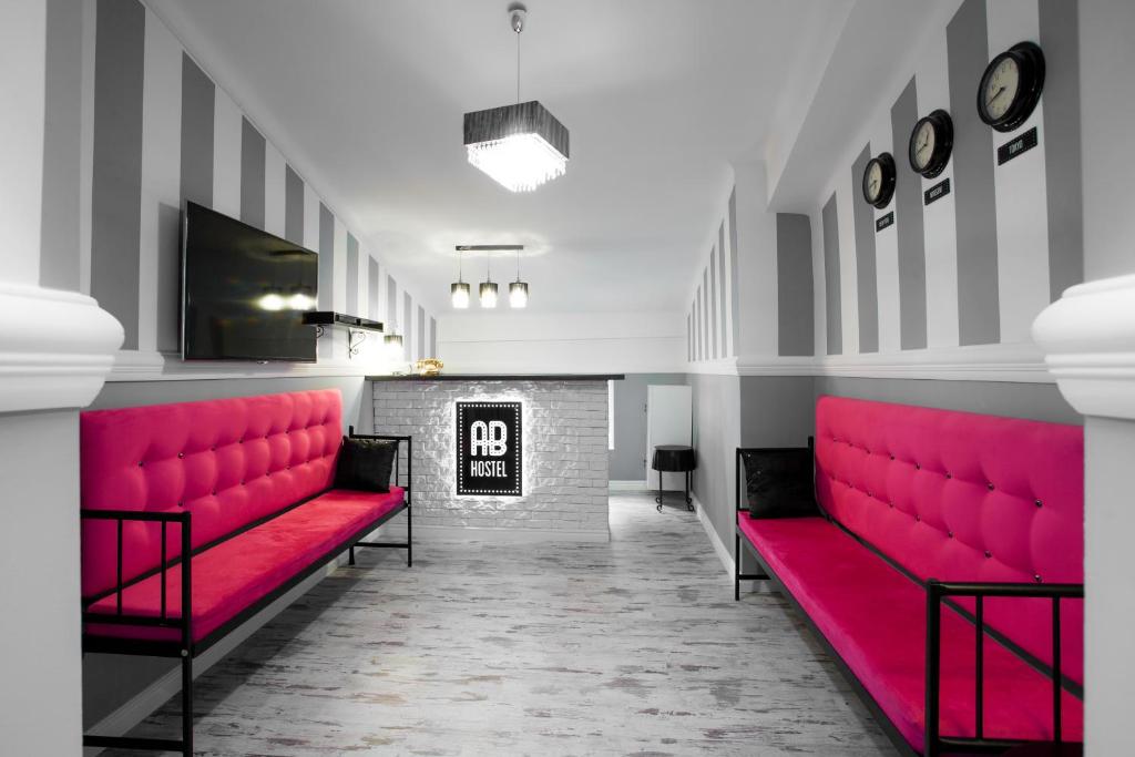 a waiting room with red benches and a fireplace at AB Hostel in Warsaw