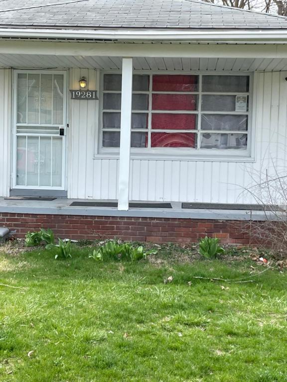 a house with a sign on the front of it at Two bedroom flat with fire place in Detroit