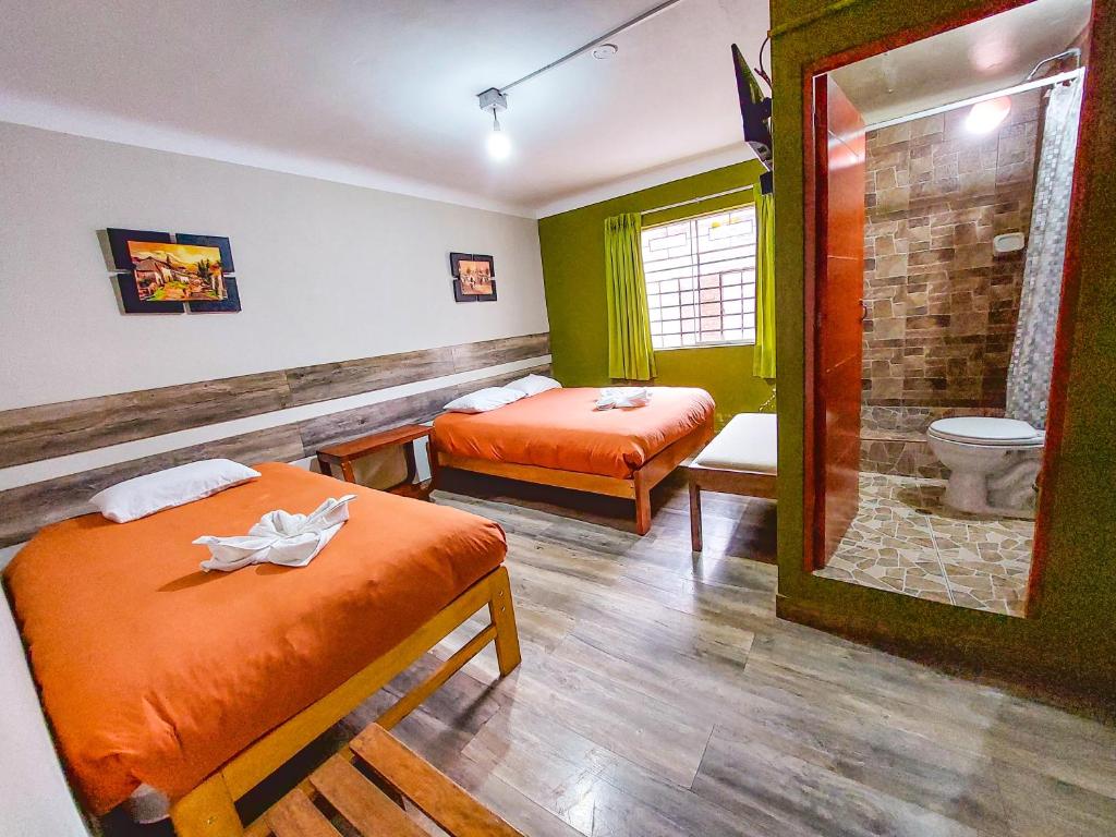 Postel nebo postele na pokoji v ubytování Ukukus Hostel
