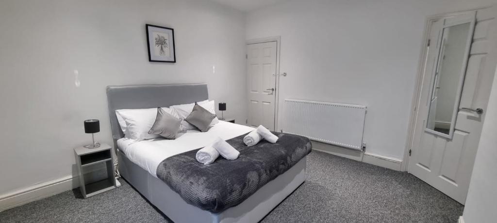 a bedroom with a bed with white sheets and pillows at Warwick St by Prestige Properties SA in Barrow in Furness