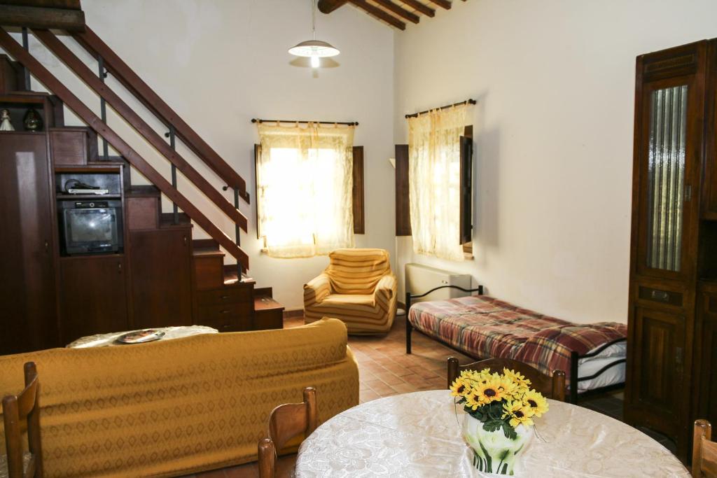 a living room with a couch and a table at Country House La Fattoria Di Paolo in Treia