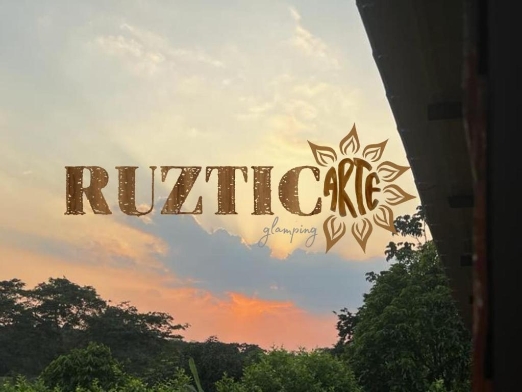 a sign that reads rivride in front of a sunset at Ruztico glamping in Villavicencio