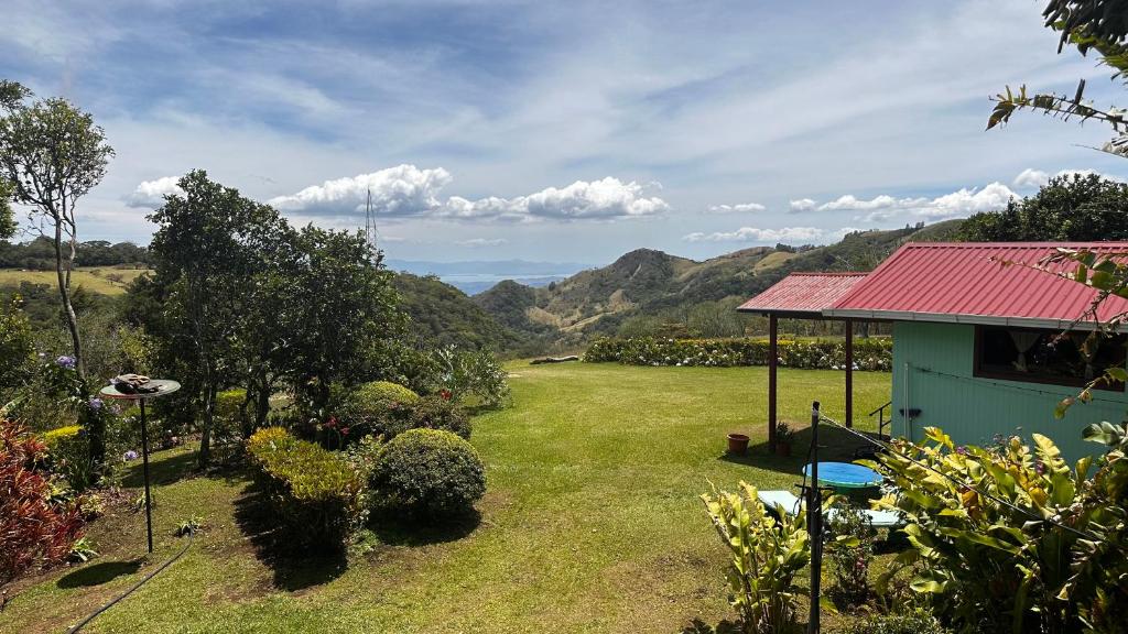 a yard with a house with a red roof at Campo Azul #3 - Monteverde in Monteverde Costa Rica