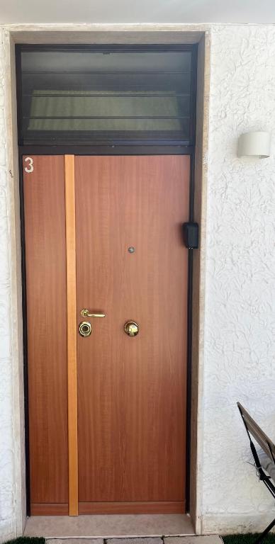 a wooden door in a building with a window at Truly Apulia in Bari