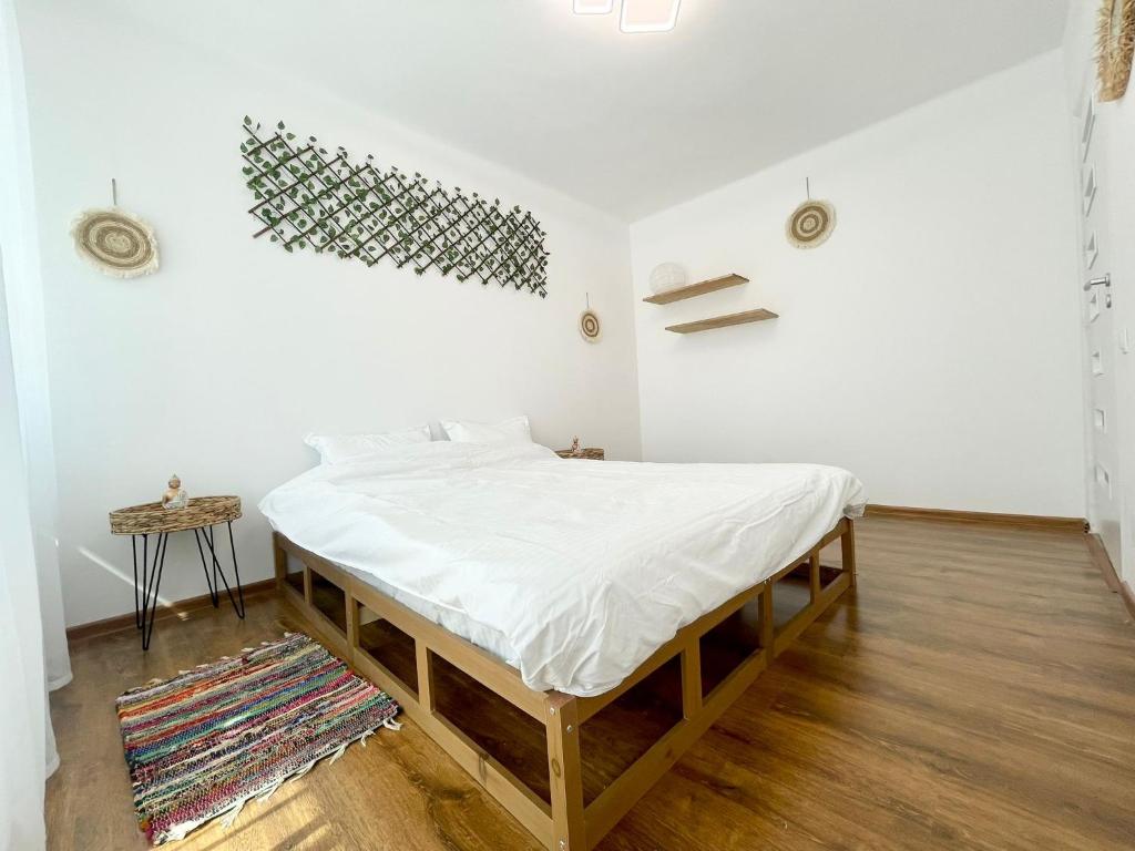 a bed in a room with a white mattress at Buddha's apartment in Cluj-Napoca