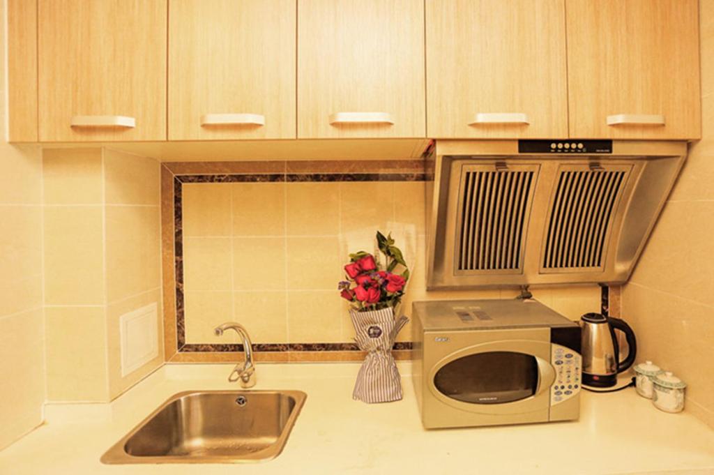 Kuchyň nebo kuchyňský kout v ubytování Dalian Hong Xi Yuan Apartment Wanda Plaza