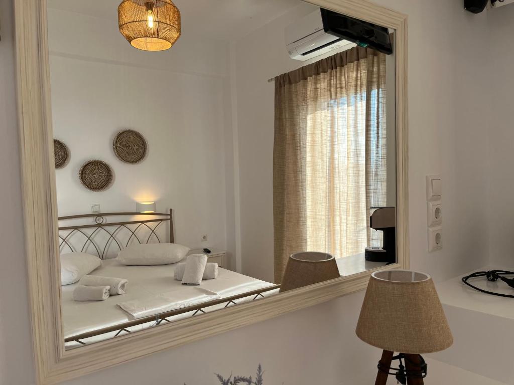 a bedroom with a large mirror and a bed at Hotel Chrisoula in Antiparos