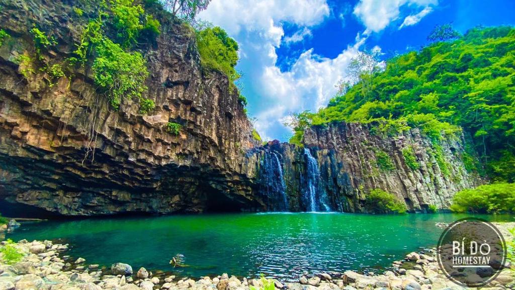 een waterval en een meer in een canyon bij Bí Đỏ homestay in Tuy Hoa