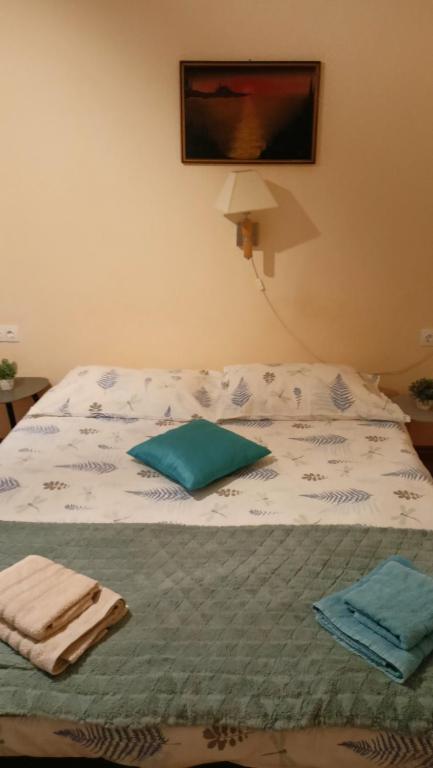 a bed with towels sitting on top of it at Apartments Magda in Cavtat