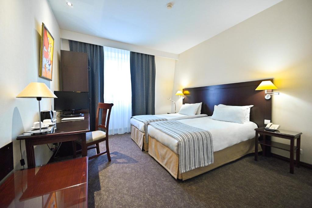 Postel nebo postele na pokoji v ubytování Europe Hotel