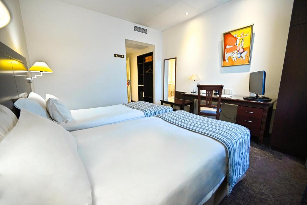 Postel nebo postele na pokoji v ubytování Europe Hotel