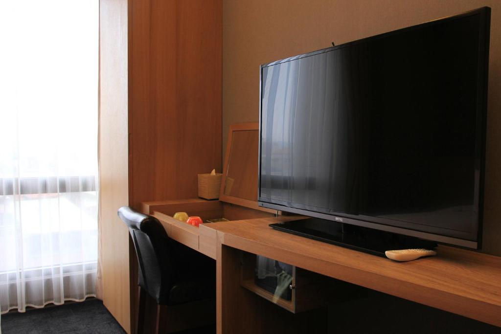 a large flat screen television sitting on a desk at Capital Hotel SongShan in Taipei