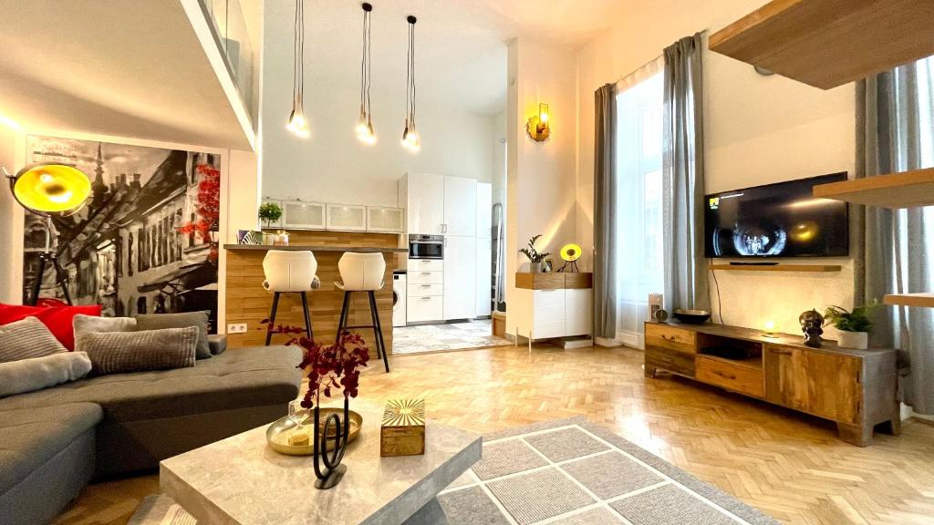 a living room with a couch and a tv at Brand New sunny apartment on Andrássy street in Budapest