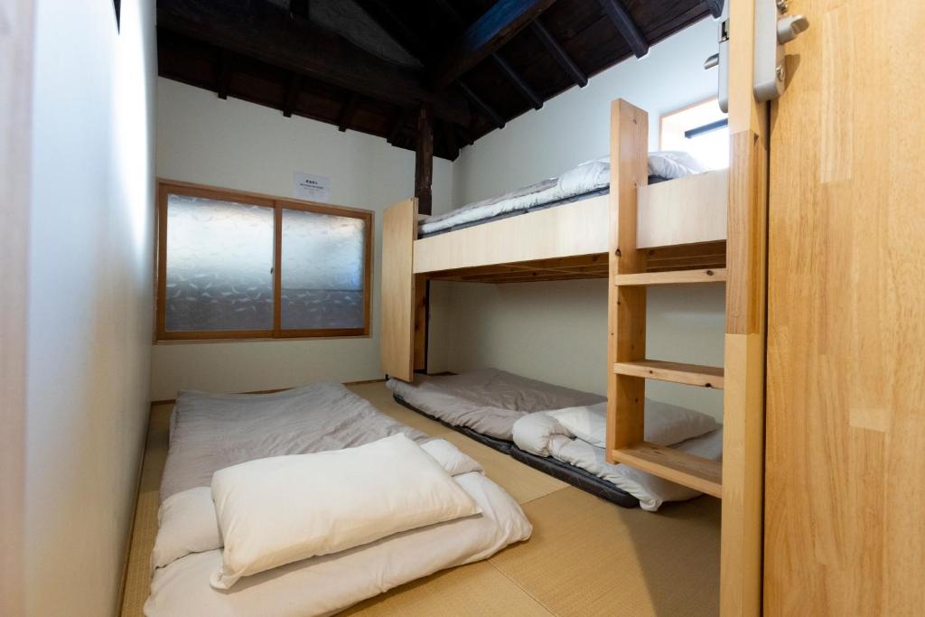 Postel nebo postele na pokoji v ubytování Cafe & Guest House Nagonoya