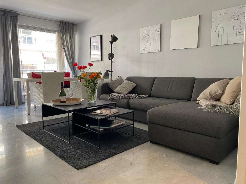 a living room with a couch and a table at Very Central apartment with Terrace in Nice