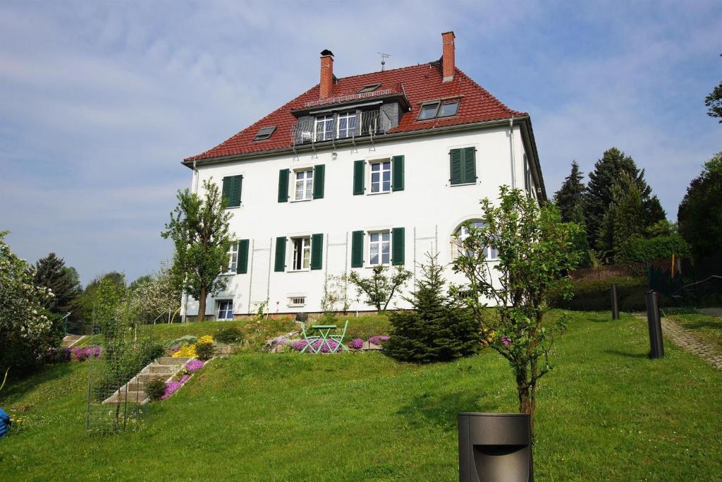 a large white house with a red roof at Villa Sonnenblick in Sebnitz