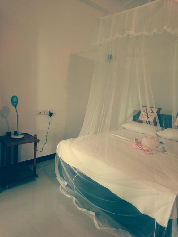 Postel nebo postele na pokoji v ubytování Dulmini Homestay