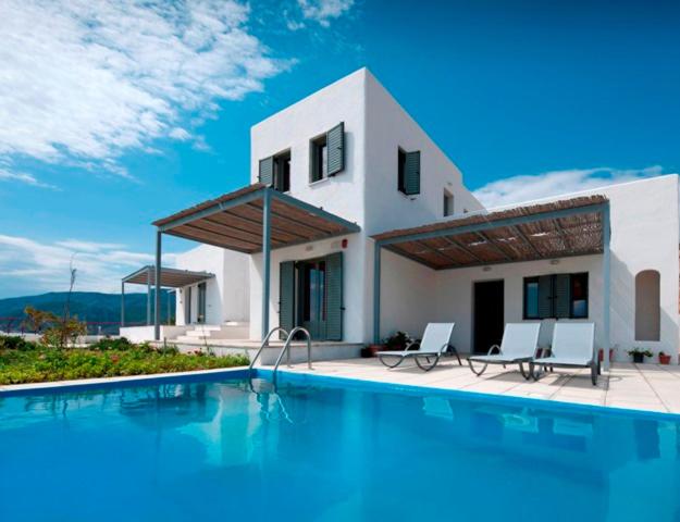 a villa with a swimming pool in front of a house at Superior Villa Lino in Skiros