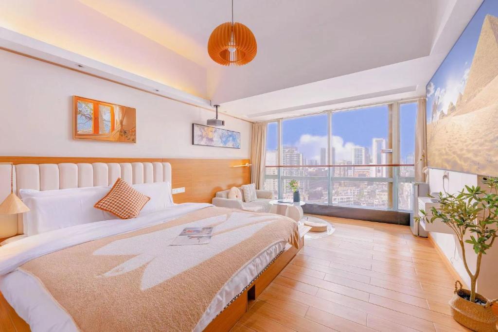 a bedroom with a large bed and a large window at Youlejia Projection Apartment Guangzhou Beijing Road Pedestrian Street Branch in Guangzhou