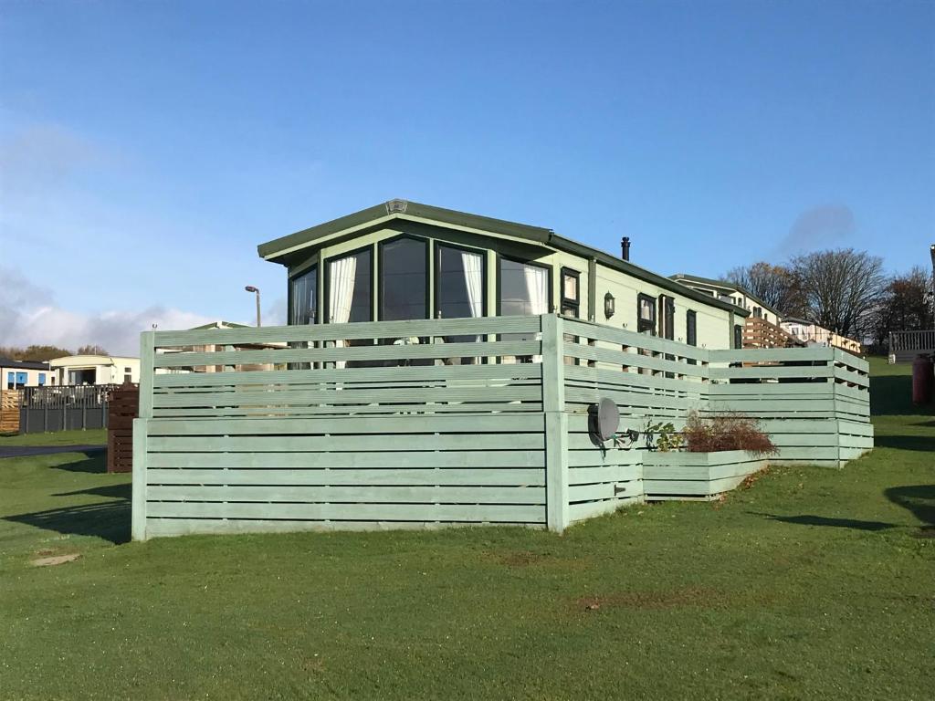 a house on top of a fence in the grass at No 70 in Newton Stewart