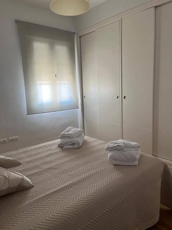 Posteľ alebo postele v izbe v ubytovaní ático con terraza- solarium