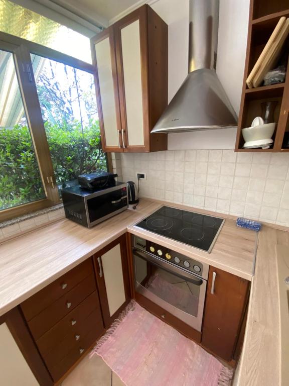 a kitchen with a stove and a microwave at Apartments Oliva in Poreč