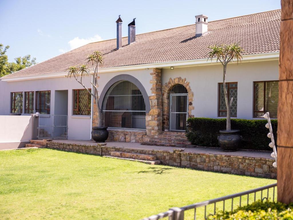 a house with a lawn in front of it at Barkly Street Guesthouse in Uitenhage