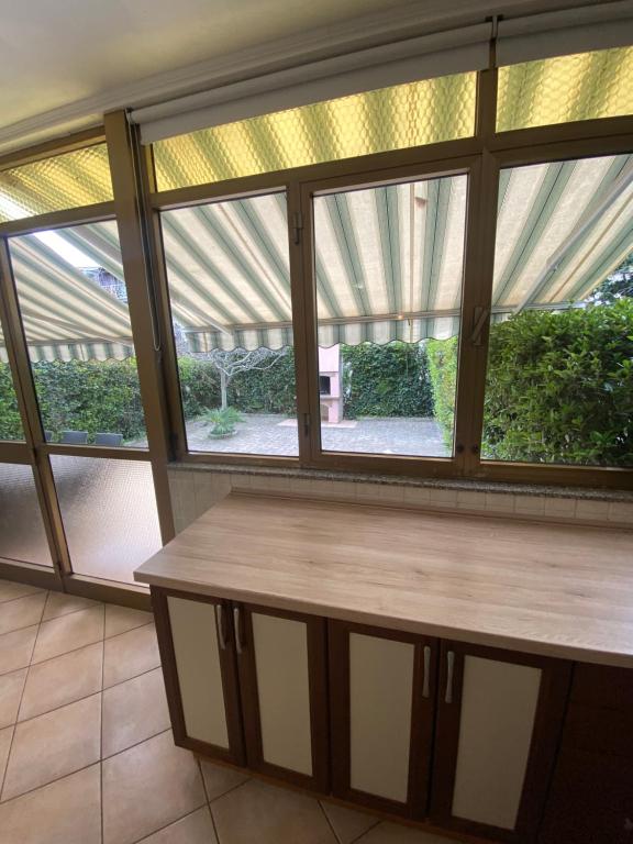 a wooden bench in a room with windows at Apartments Oliva in Poreč