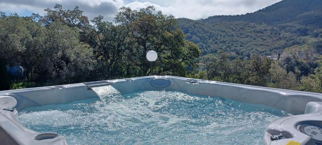 a hot tub with water in it in the mountains at Duca House in San Giovanni