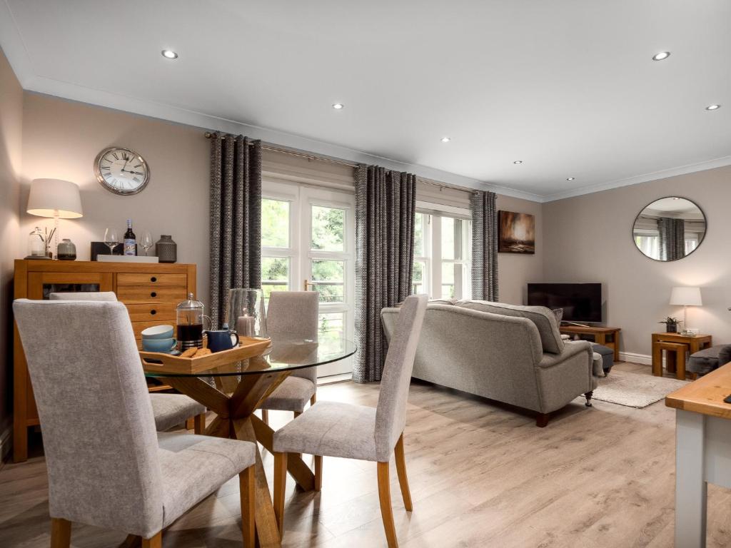 a living room with a table and chairs and a couch at Durham Riverside Apartments in Durham