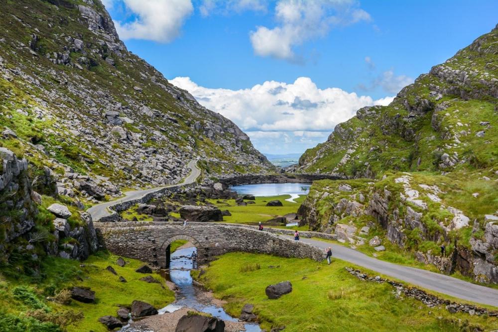 a stone bridge over a river in a mountain at Location, Location! Gorgeous 1 Bed Apt- Killarney in Killarney