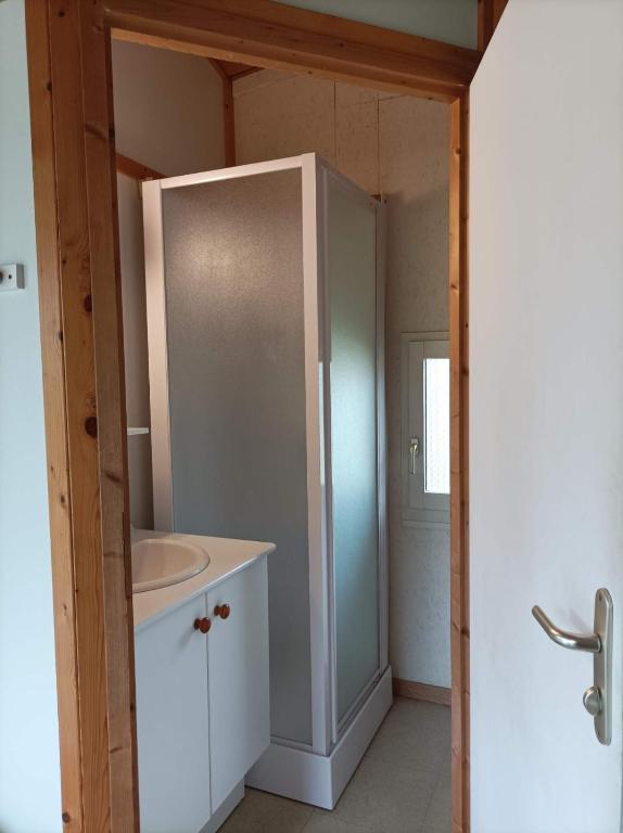 a bathroom with a sink and a white cabinet at CAMPING DE LA CHALARONNE in Saint-Didier-sur-Chalaronne