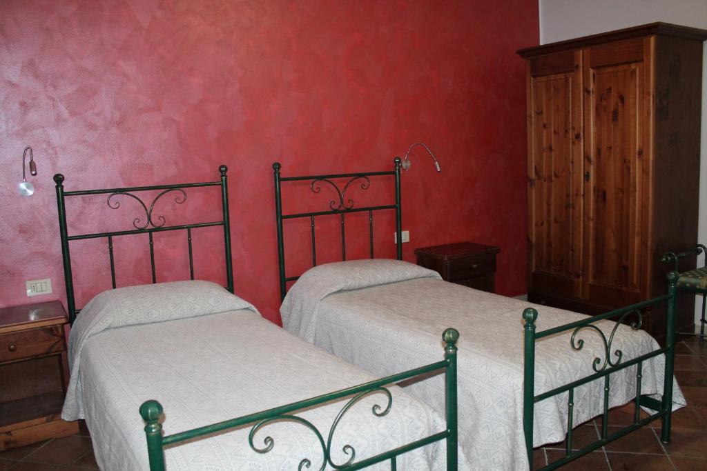 Postel nebo postele na pokoji v ubytování Agriturismo San Bartolomeo
