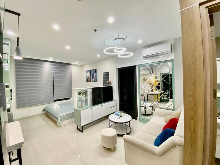 un salon avec un canapé et une télévision dans l'établissement Vinhomes Smartcity-Căn hộ dich vụ-Zhomestay, à Phú Thú