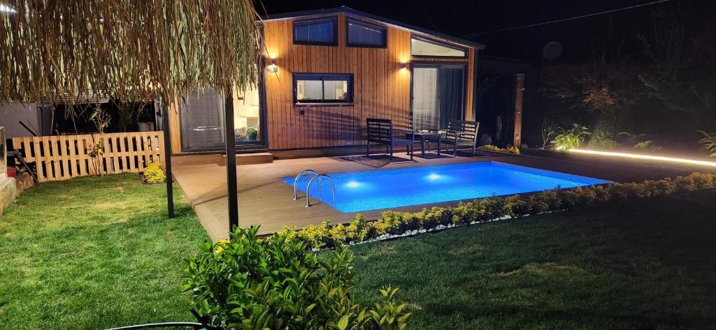 a swimming pool in a backyard at night at Arkaya TinyHouse in Fethiye
