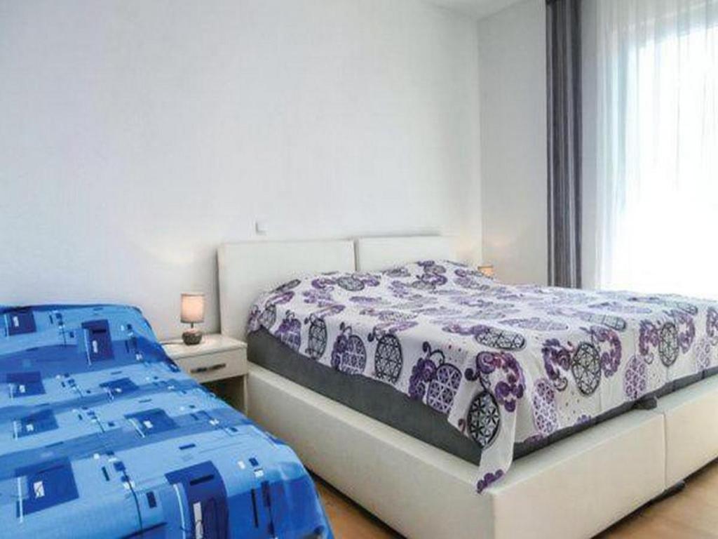 Postel nebo postele na pokoji v ubytování Apartment Stipic Omis