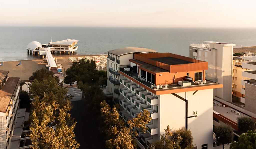 an aerial view of a building with the ocean in the background at Hotel Lampara in Lignano Sabbiadoro