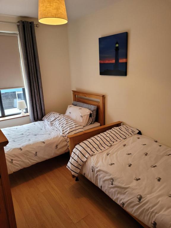 Postel nebo postele na pokoji v ubytování Broadhaven Bay Apartment