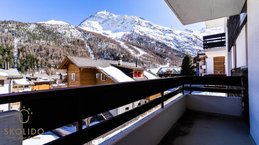 a balcony with a view of a snow covered mountain at Haus Camillo in Saas-Fee